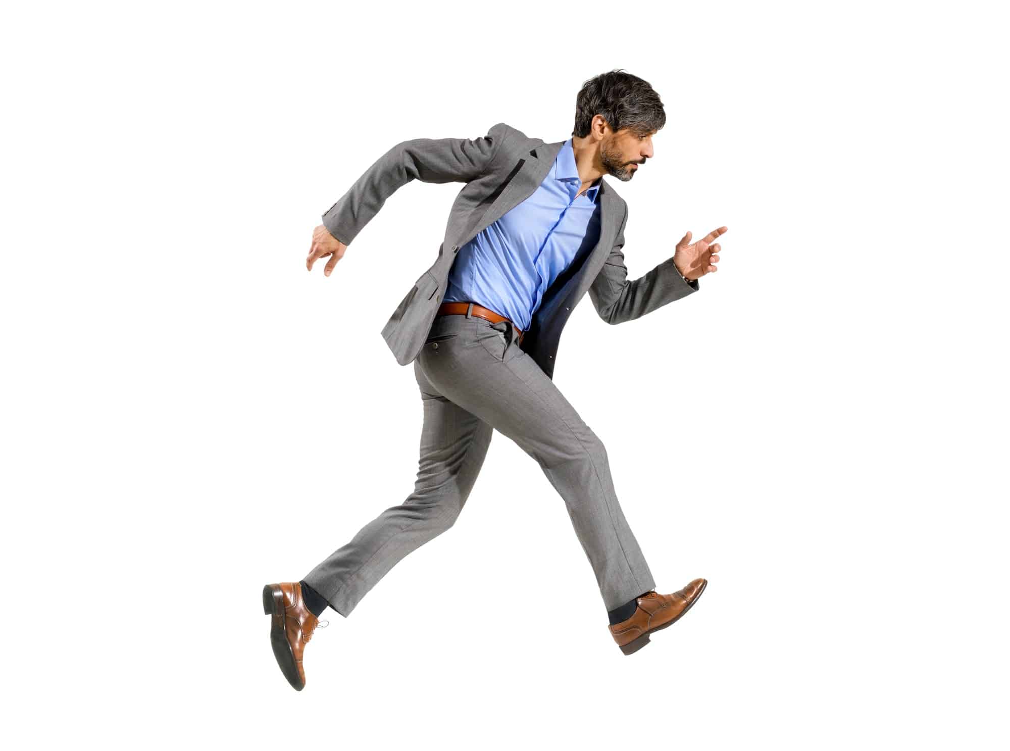 Businessman in a stylish suit walking very fast in a hurry