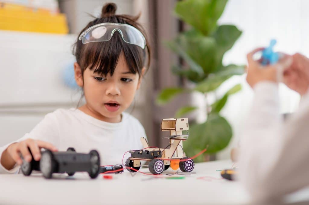 Asia students learn at home in coding robot cars and electronic board cables in STEM,